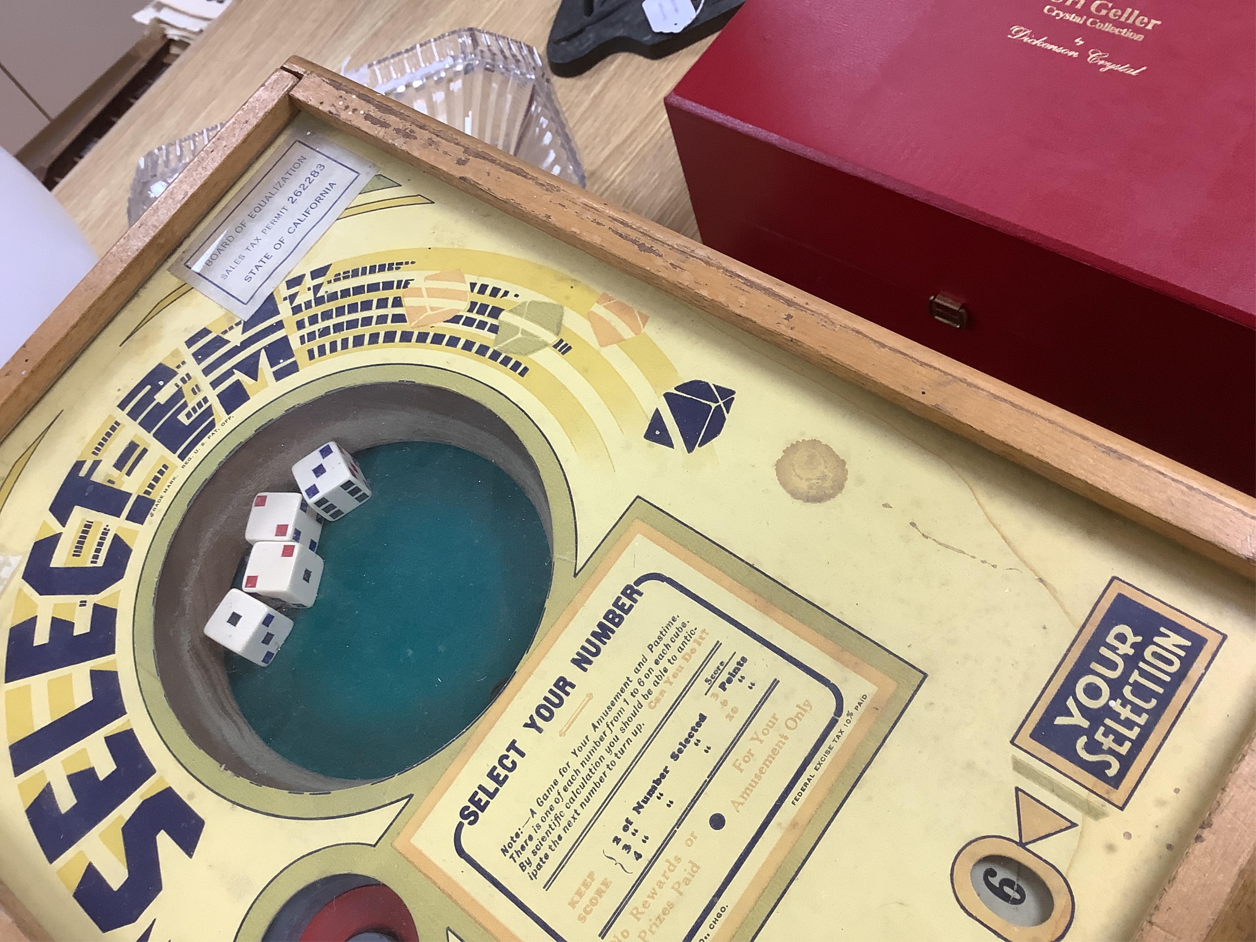 A ‘Select-Em’ table top pinball style dice game in a teak frame dated 1933, with Board of Equalization sales tax permit label for the State of California, 26cm wide, 35.5cm deep, 12.5cm high